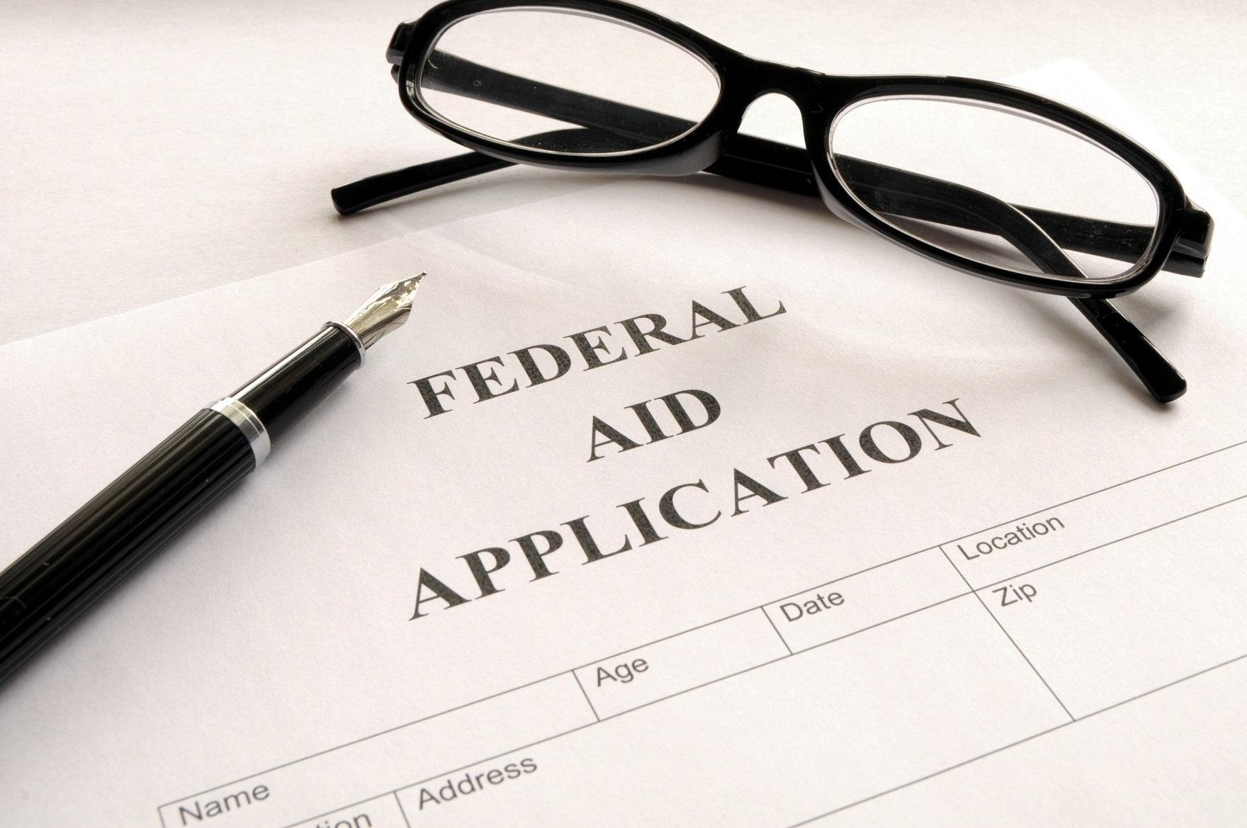 pen and glasses on federal student aid application