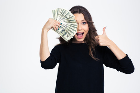 portrait of a cheerful girl covering her eye with dollar bills and showing thumb up - concept for easy $500 scholarships