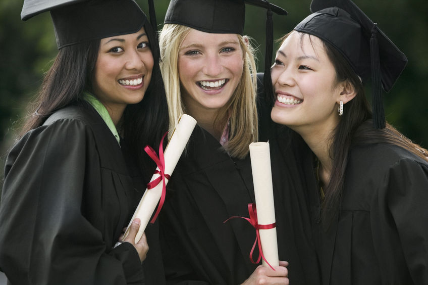 three young female graduates standing together holding diplomas smiling - concept for Scholarships that no one applies for