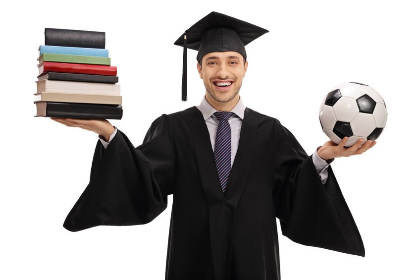 happy graduate student holding a stack of books and a football concept for Easiest Sports Scholarships To Get