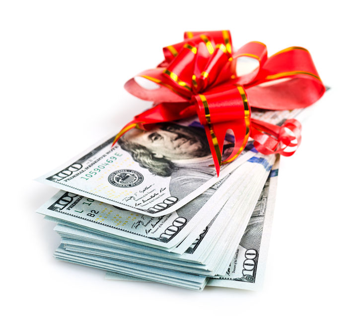 money gift, big stack of dollars with red bow concept for bonus scholarship winners