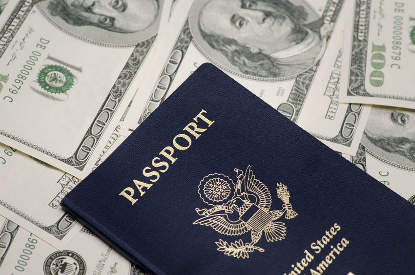 US passport and pile of us dollar money concept for study abroad funding