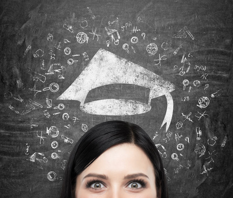  a head of young brunette lady who is thinking about university education. drawn educational icons and a graduation hat on the black chalkboard background concept for AP Scholar Awards