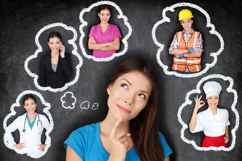 education and career choice options - student thinking of future. young asian woman contemplating career options smiling looking up at thought bubbles on a blackboard with different professions concept for internship opportunities