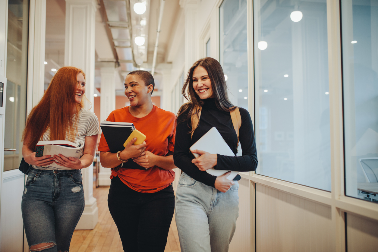 Female high school students walking after lecture 