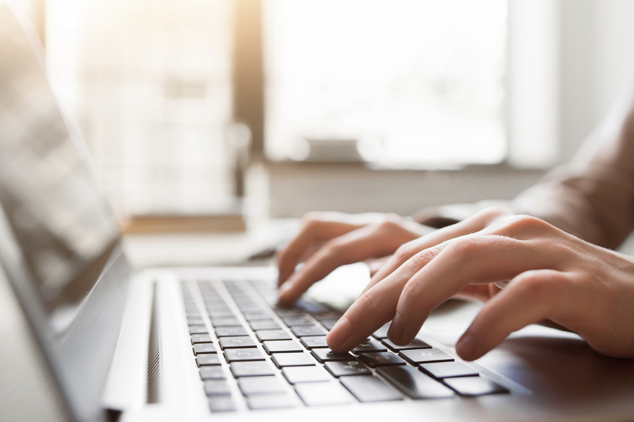 Typing on laptop closeup representing someone choosing a technology or AI college major