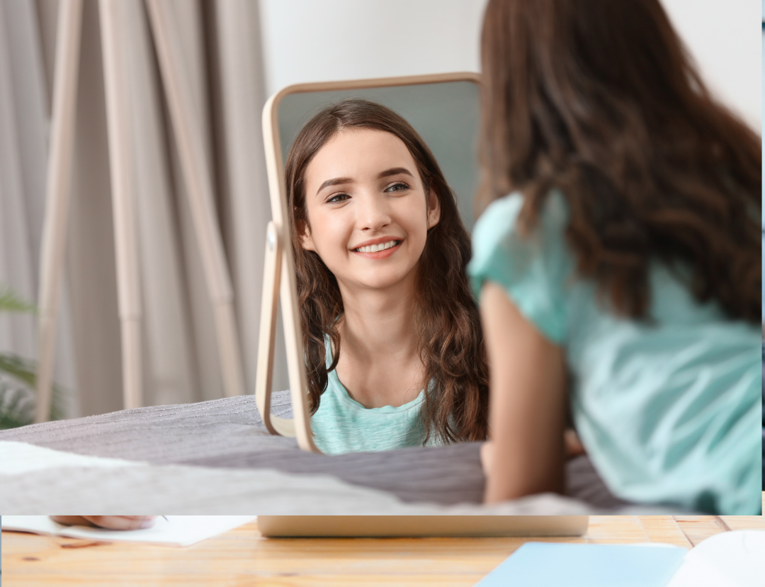 confident teen looking in the mirror proud of her scholarship success