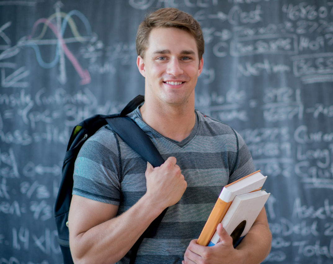 ollege student in front of math board