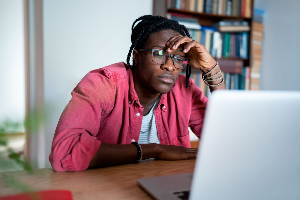Disappointed student loan borrower looking at laptop