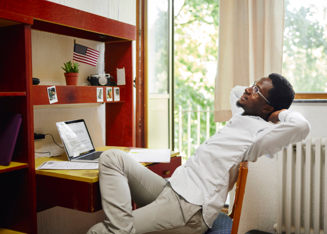 college student sitting at his desk 