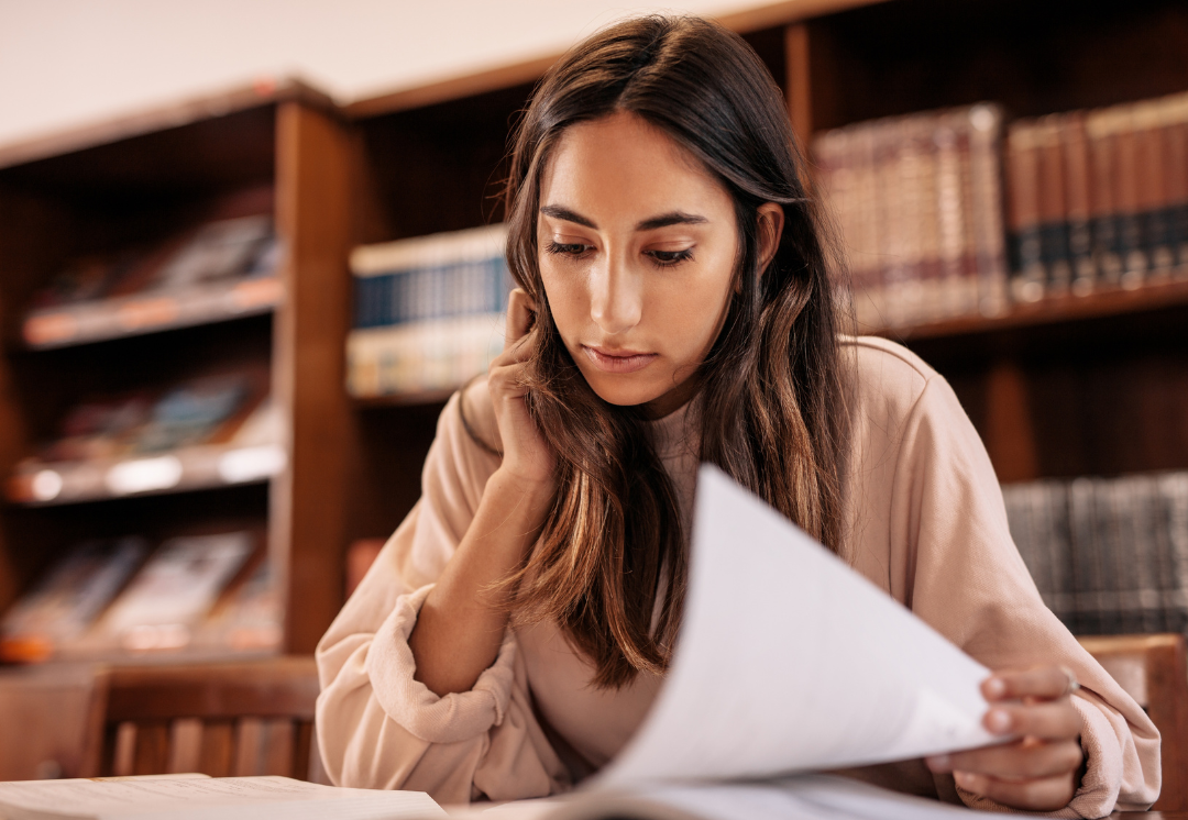 college student flipping through papers