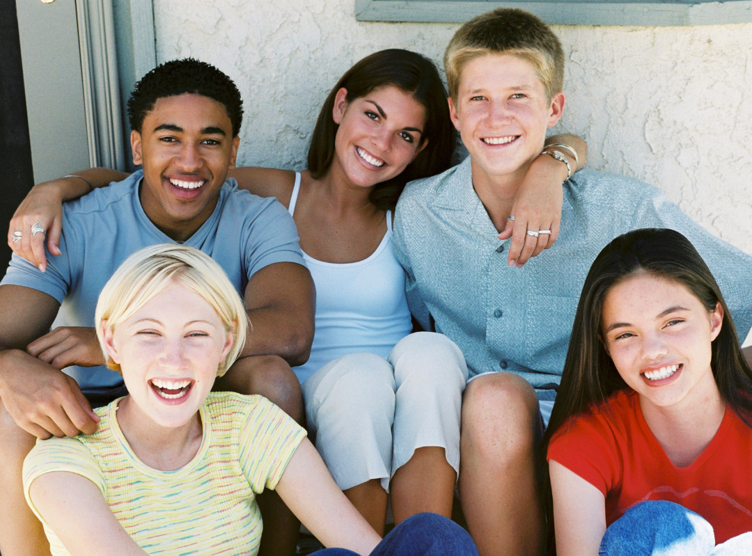 group of teens taking selfie