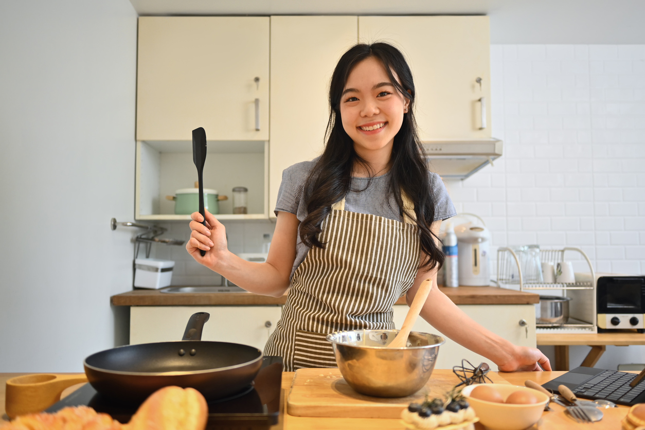 Cheerful student cooking