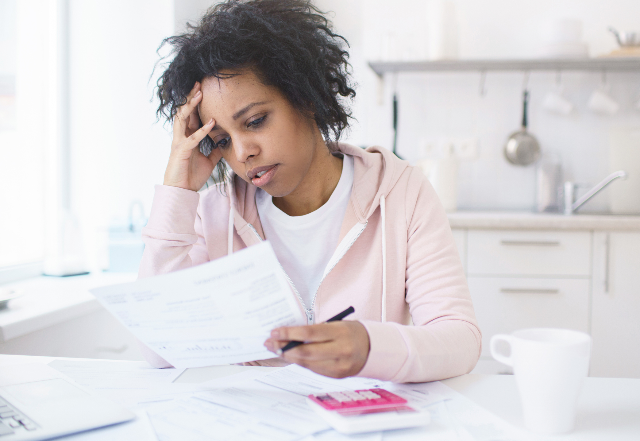 upset women receives a wage garnishment notice about her defaulted student loans